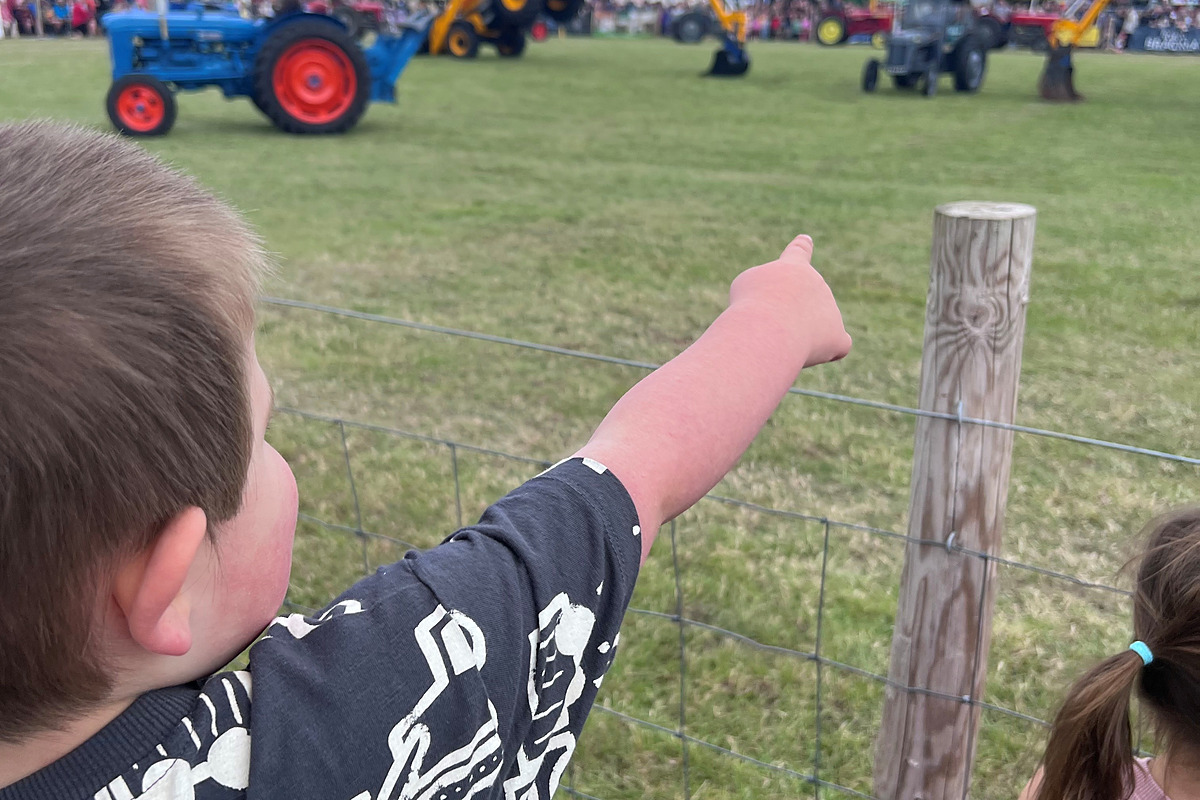 Alana Mackenzie of Mackenzie Commercial Finance and her son looking at JCB backhoe loaders at the Nairn Show.